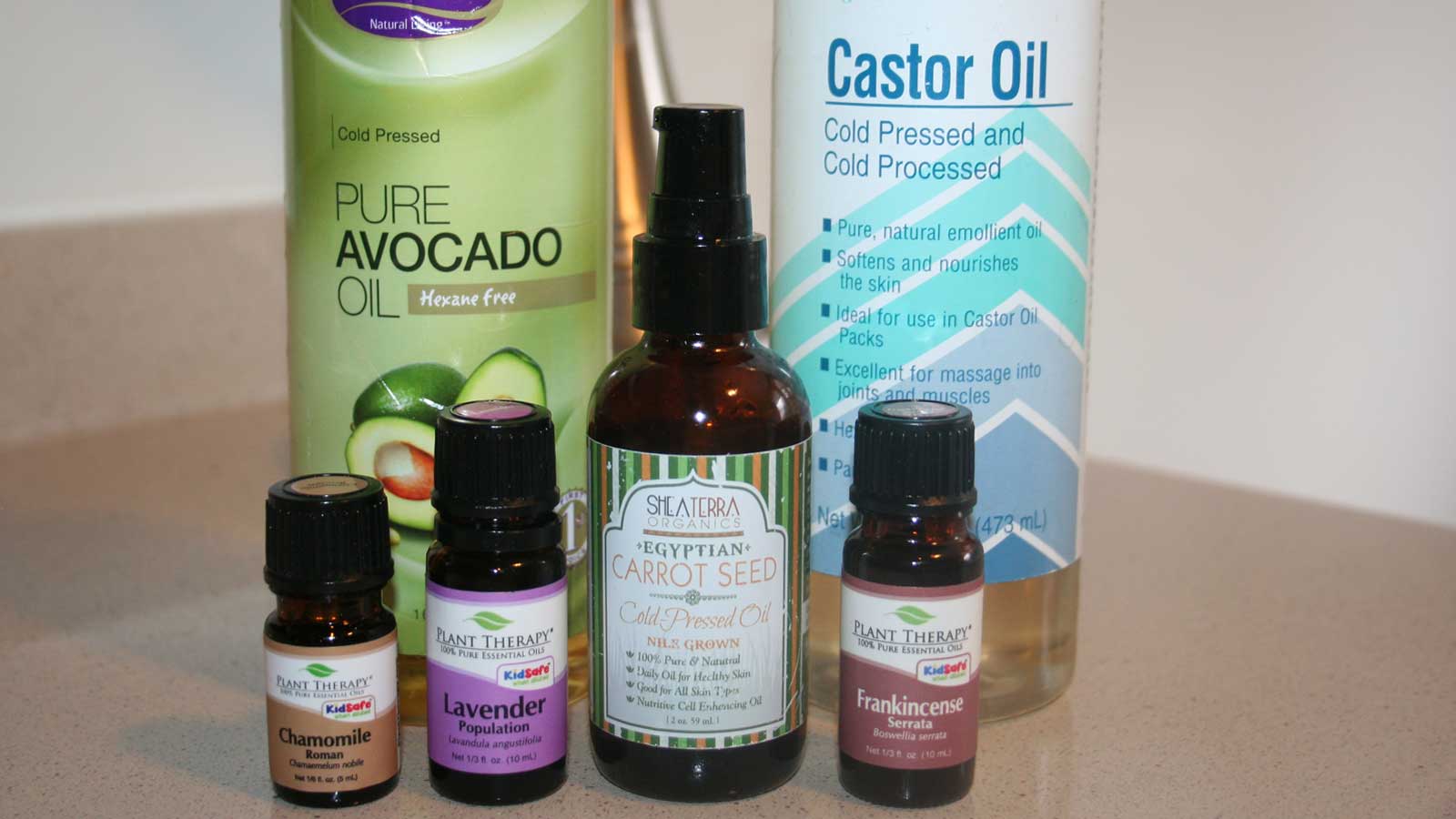 Ingredients for the oil cleansing method, including avocado oil, castor oil, carrot seed oil and plant therapy essential oils.