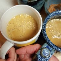 Salted Caramel Apple Cider in mugs with mama's hands and child's hands