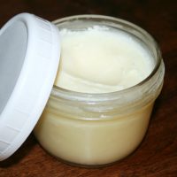 Easy Homemade Deodorant in a Jar with Plastic Lid off to the Side