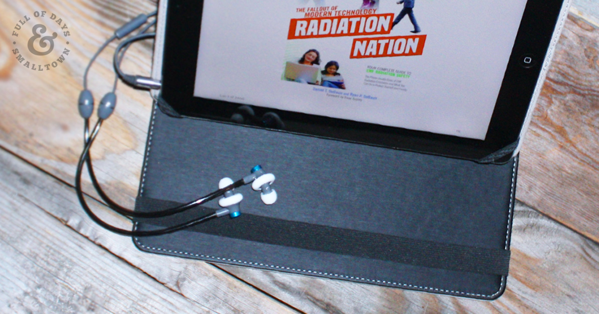 DefenderShield iPad cover and EMF blocking ear buds with Radiation Nation loaded on the screen