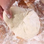 Grab the dough at 9 o'clock, lift and pull toward the center of the dough.