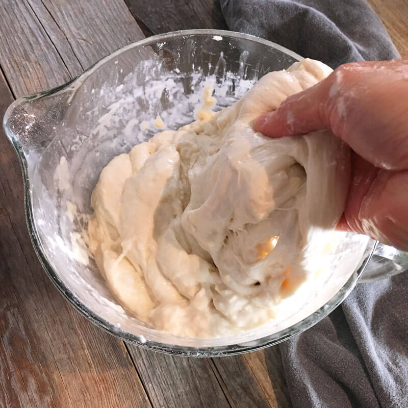 Stretch and fold your dough by grabbing the dough and stretching up.
