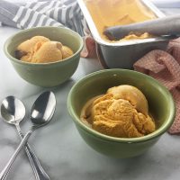 Carrot Cake Ice Cream served in two green bowls with spoons, ready to eat and enjoy.