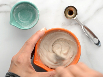 Whisking the coconut filling together with a fork until it's smooth and creamy.