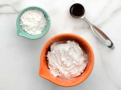 Coconut cream, powdered sugar and vanilla extract ready to be mixed together for the sweet coconut cream filling for these healthy homemade oreos.