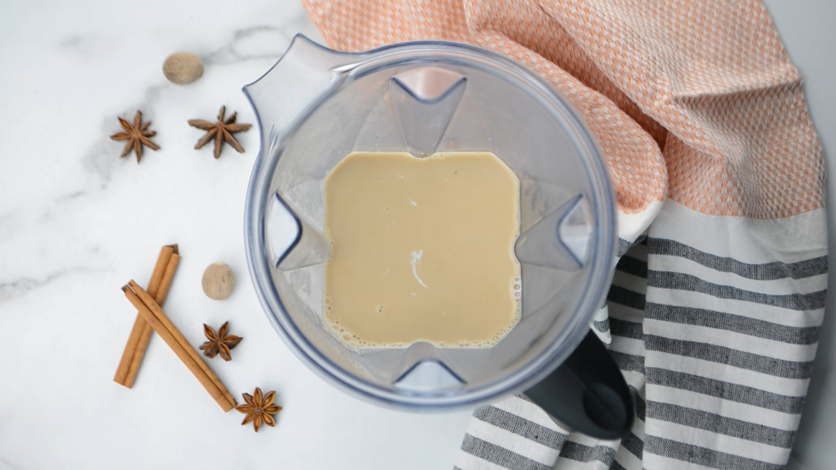 A blender with chai tea latte inside.